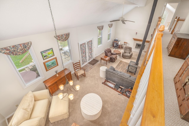 6181 Perry Rd, Centerburg, OH 43011 - carpeted living area with vaulted ceiling, a tiled fireplace, and ceiling fan
