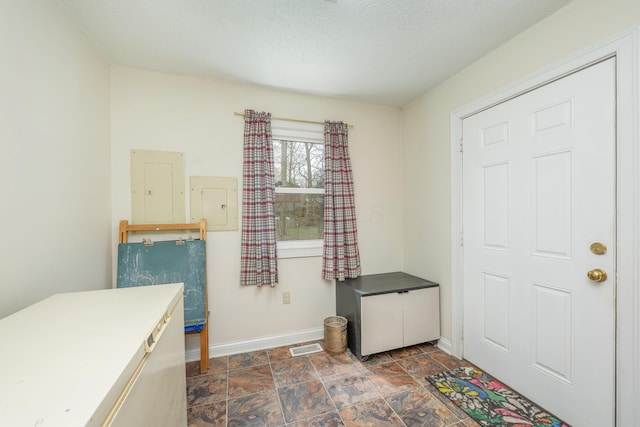 6181 Perry Rd, Centerburg, OH 43011 - interior space featuring baseboards, stone finish floor, a textured ceiling, and electric panel