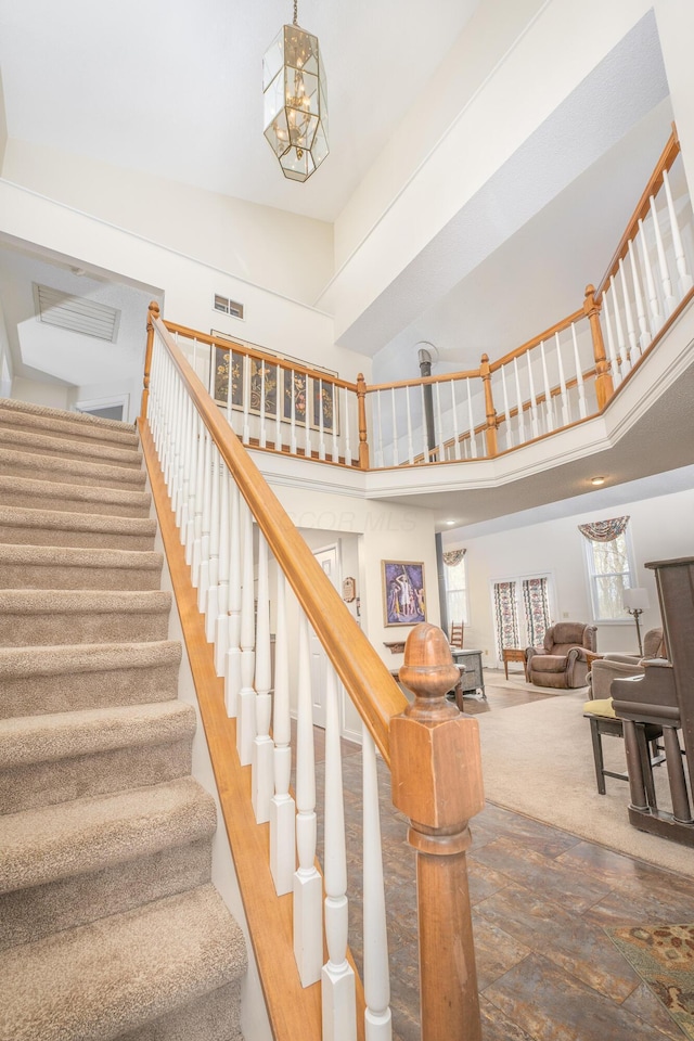 6181 Perry Rd, Centerburg, OH 43011 - stairway with a towering ceiling, wood finished floors, and visible vents