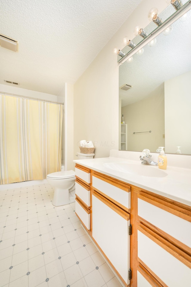 6181 Perry Rd, Centerburg, OH 43011 - bathroom featuring tile patterned floors, a textured ceiling, vanity, toilet, and visible vents