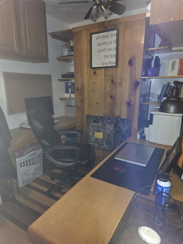 interior space with wood finished floors and ceiling fan