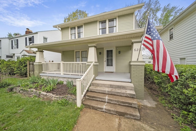 traditional style home featuring covered porch