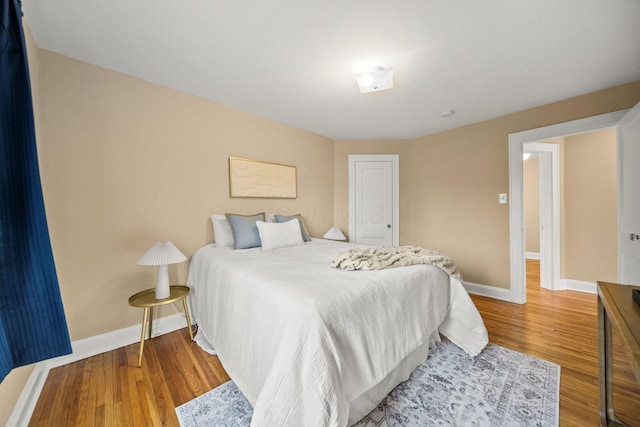 bedroom featuring baseboards and wood finished floors