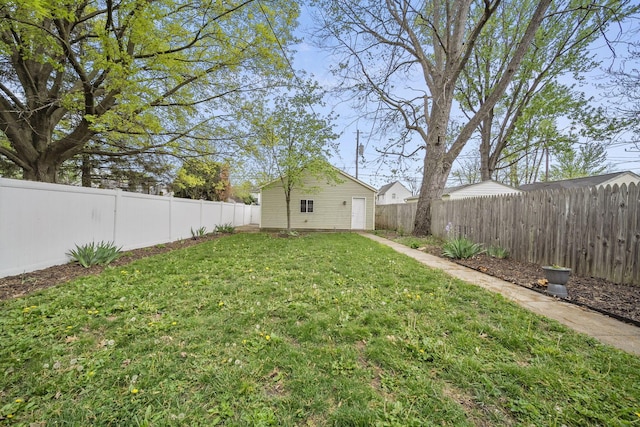 view of yard with a fenced backyard and an outbuilding