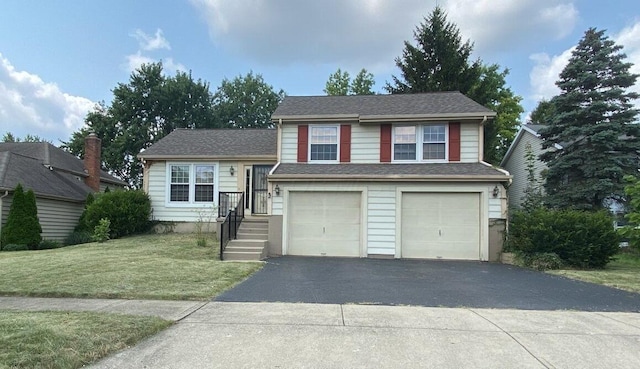 split level home featuring a garage, driveway, and a front yard