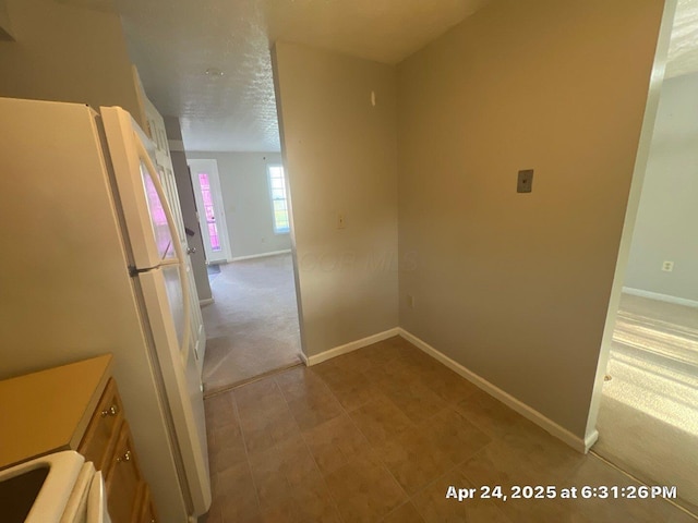 hallway featuring baseboards