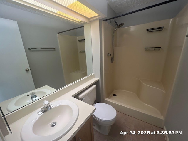 bathroom with walk in shower, toilet, and vanity