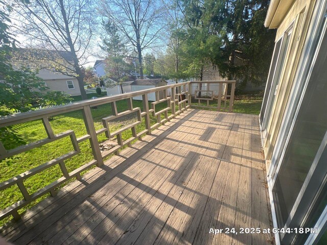 wooden deck with a lawn