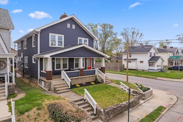 1284-1286 S Champion Ave, Columbus, OH 43206 - american foursquare style home featuring a front yard, a porch, and a chimney
