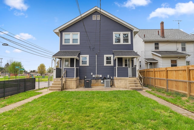 1284-1286 S Champion Ave, Columbus, OH 43206 - rear view of house featuring a lawn, a chimney, central air condition unit, and a fenced backyard