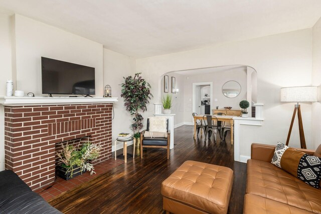 1284-1286 S Champion Ave, Columbus, OH 43206 - living room featuring wood-type flooring, baseboards, and a brick fireplace