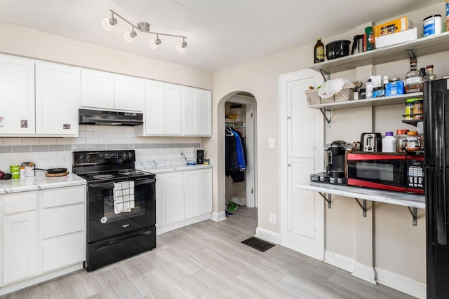 1284-1286 S Champion Ave, Columbus, OH 43206 - kitchen featuring white cabinetry, open shelves, arched walkways, black appliances, and under cabinet range hood