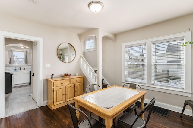 1284-1286 S Champion Ave, Columbus, OH 43206 - dining area featuring dark wood finished floors, stairway, and baseboards