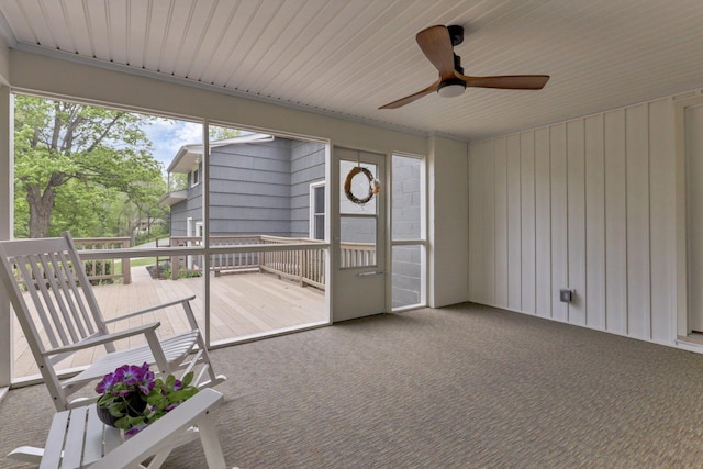 unfurnished sunroom with a ceiling fan