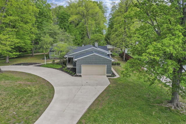 view of property's community featuring a yard, driveway, and a garage