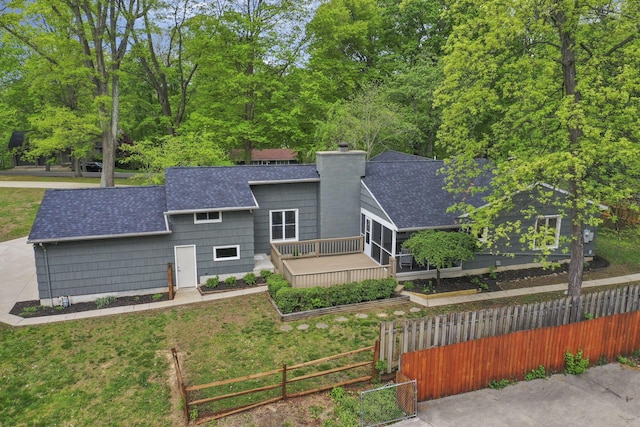 view of front of house featuring a shingled roof, fence private yard, and a chimney