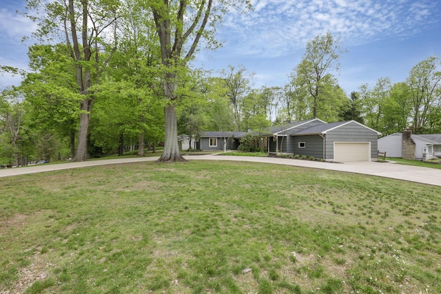 single story home with a garage, concrete driveway, and a front lawn