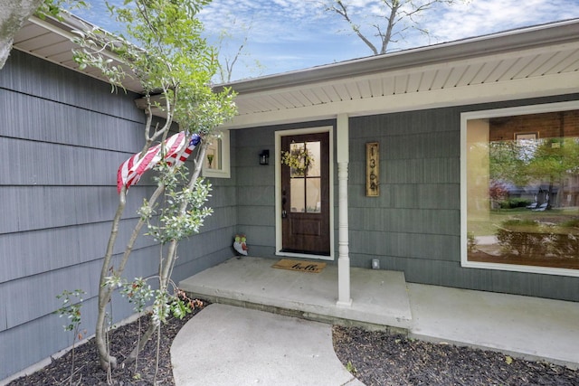 view of exterior entry with a porch