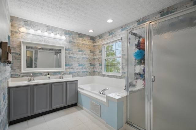 bathroom featuring visible vents, a stall shower, a textured ceiling, and a garden tub