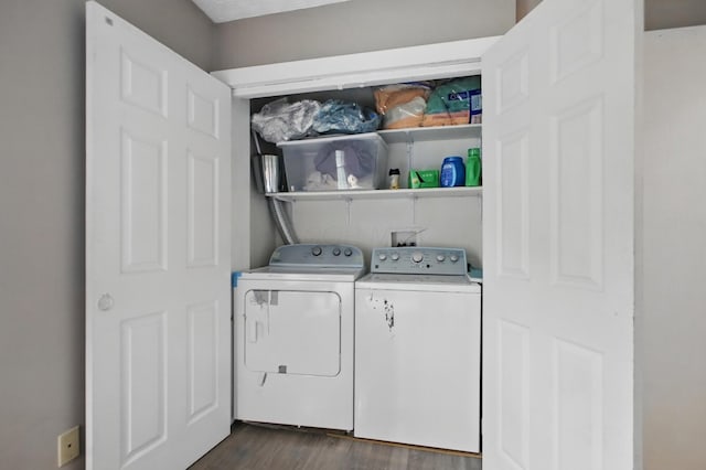 washroom with separate washer and dryer, laundry area, and dark wood finished floors