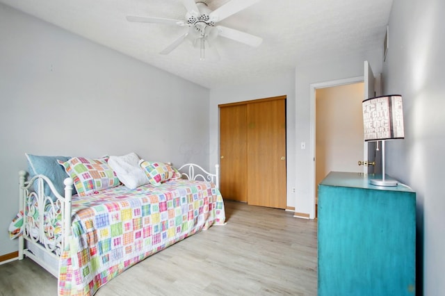 bedroom with baseboards, wood finished floors, and a ceiling fan
