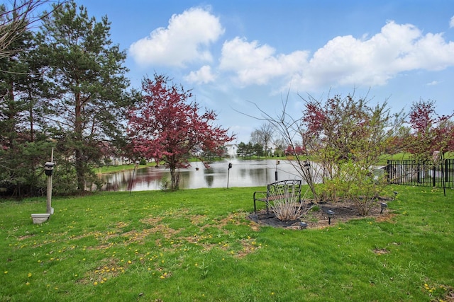 view of yard with fence and a water view