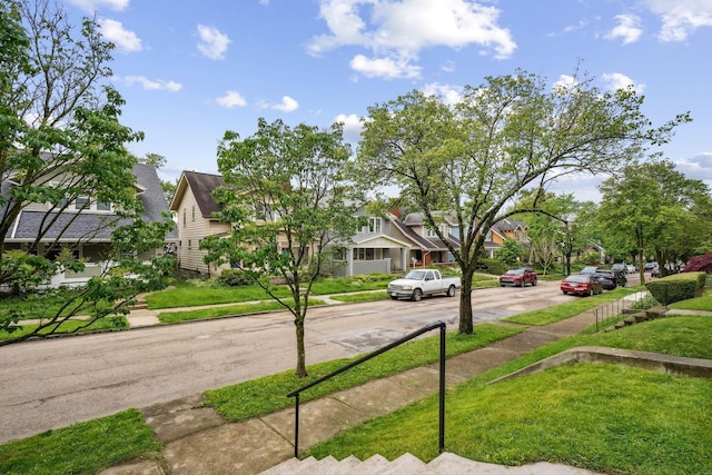 view of asphalt road featuring sidewalks and a residential view