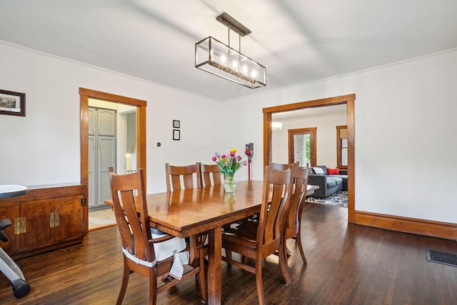 dining room featuring wood finished floors and a chandelier