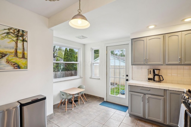 entryway with baseboards, light tile patterned floors, and recessed lighting