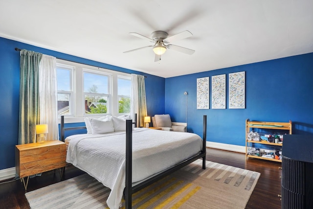 bedroom with baseboards, wood finished floors, and a ceiling fan