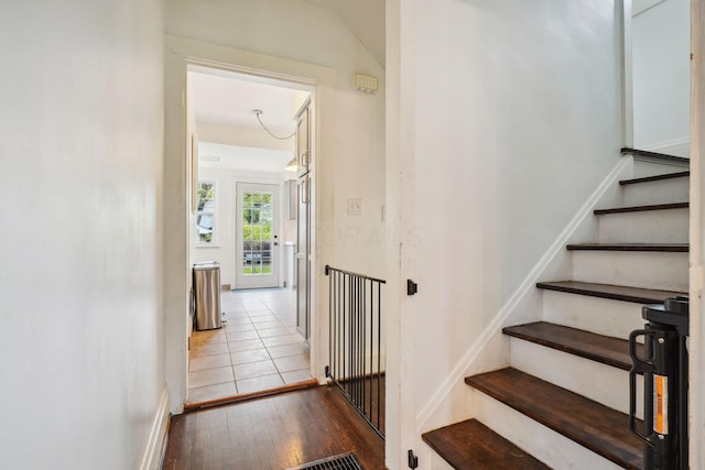 stairway with hardwood / wood-style floors and baseboards