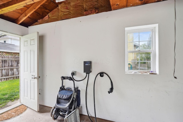 misc room featuring vaulted ceiling and unfinished concrete floors
