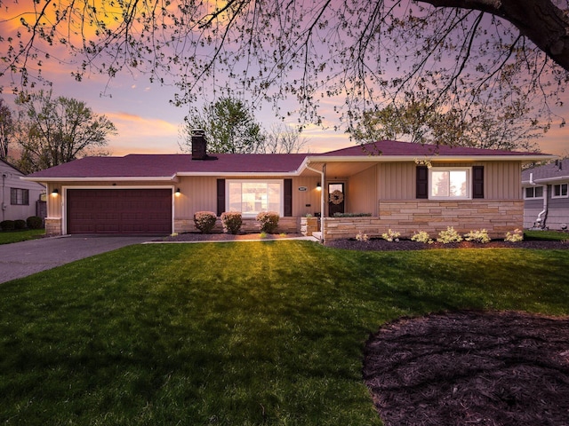 ranch-style house featuring driveway, a chimney, a front yard, a garage, and stone siding