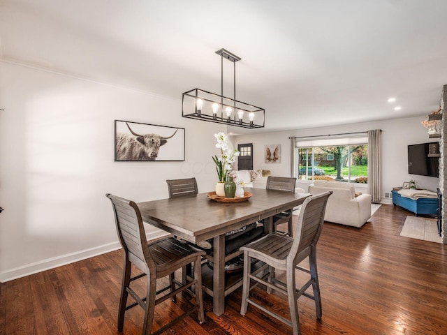 dining room featuring an inviting chandelier, baseboards, and dark wood-type flooring