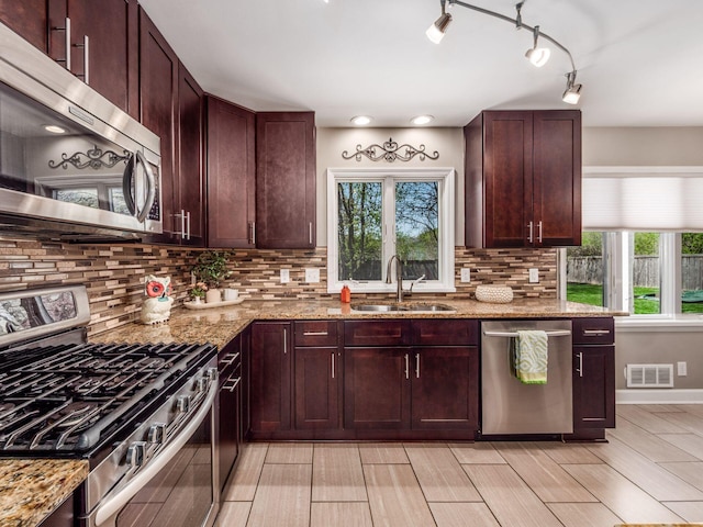 kitchen with visible vents, a sink, a healthy amount of sunlight, and stainless steel appliances