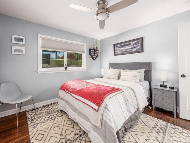 bedroom featuring baseboards, a ceiling fan, and wood finished floors