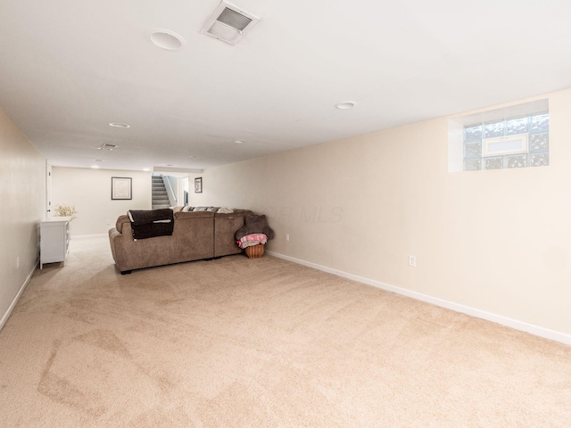 living room with baseboards, carpet, stairs, and visible vents