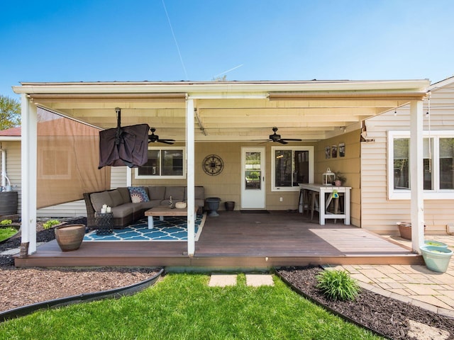 rear view of property with a deck, ceiling fan, and outdoor lounge area