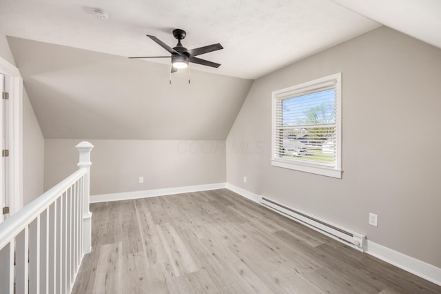 116 W S Ave, Plain City, OH 43064 - additional living space with a baseboard radiator, wood finished floors, a ceiling fan, and vaulted ceiling