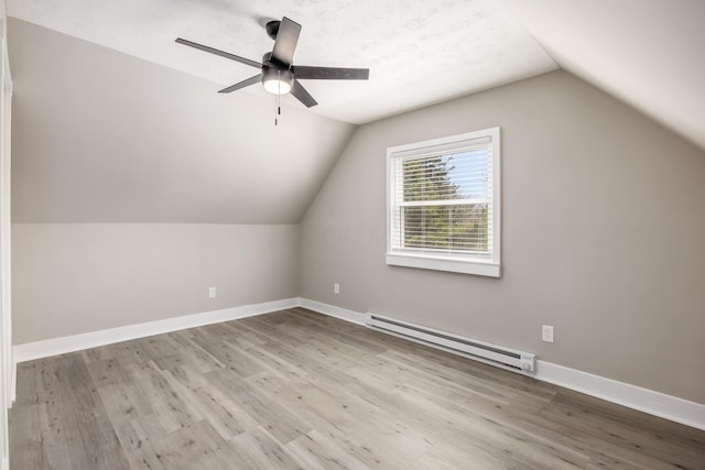 116 W S Ave, Plain City, OH 43064 - bonus room featuring a baseboard heating unit, a ceiling fan, vaulted ceiling, and wood finished floors