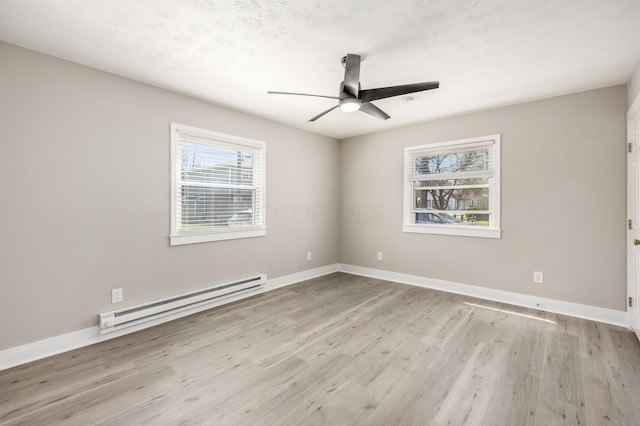 116 W S Ave, Plain City, OH 43064 - unfurnished room with wood finished floors, plenty of natural light, a ceiling fan, and baseboard heating