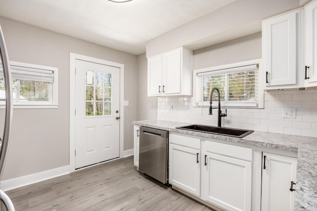 116 W S Ave, Plain City, OH 43064 - kitchen featuring a sink, decorative backsplash, light wood-style floors, a wealth of natural light, and dishwasher