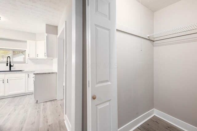 116 W S Ave, Plain City, OH 43064 - interior space with light wood-style floors, baseboards, and a sink