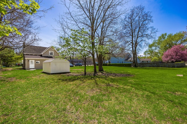 116 W S Ave, Plain City, OH 43064 - view of yard featuring fence, a storage unit, and an outbuilding