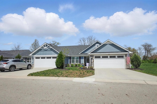 craftsman-style home with a garage, board and batten siding, driveway, and stone siding