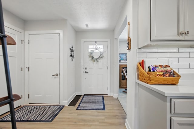 interior space with baseboards and light wood-style flooring