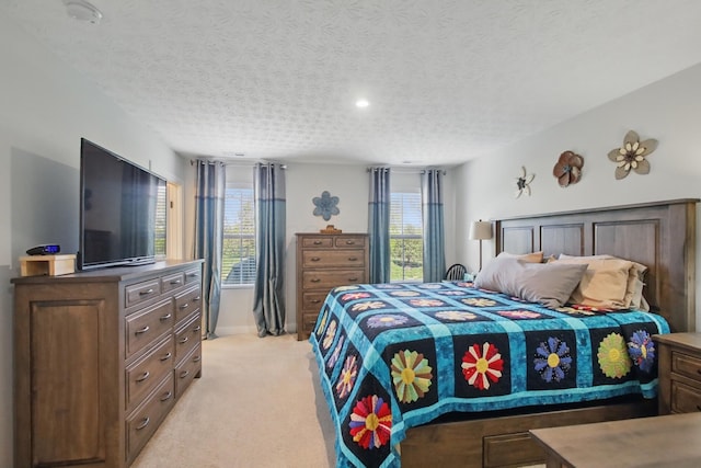 bedroom featuring recessed lighting, a textured ceiling, and light colored carpet