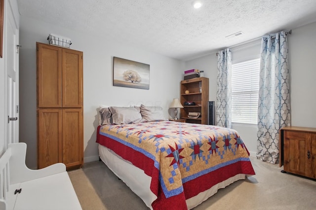 bedroom with a textured ceiling, light colored carpet, visible vents, baseboards, and recessed lighting