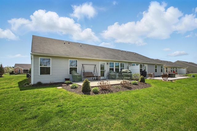 back of property with a yard and a patio area