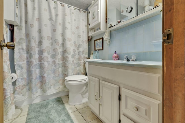 full bath featuring tile patterned floors, backsplash, toilet, vanity, and a textured ceiling